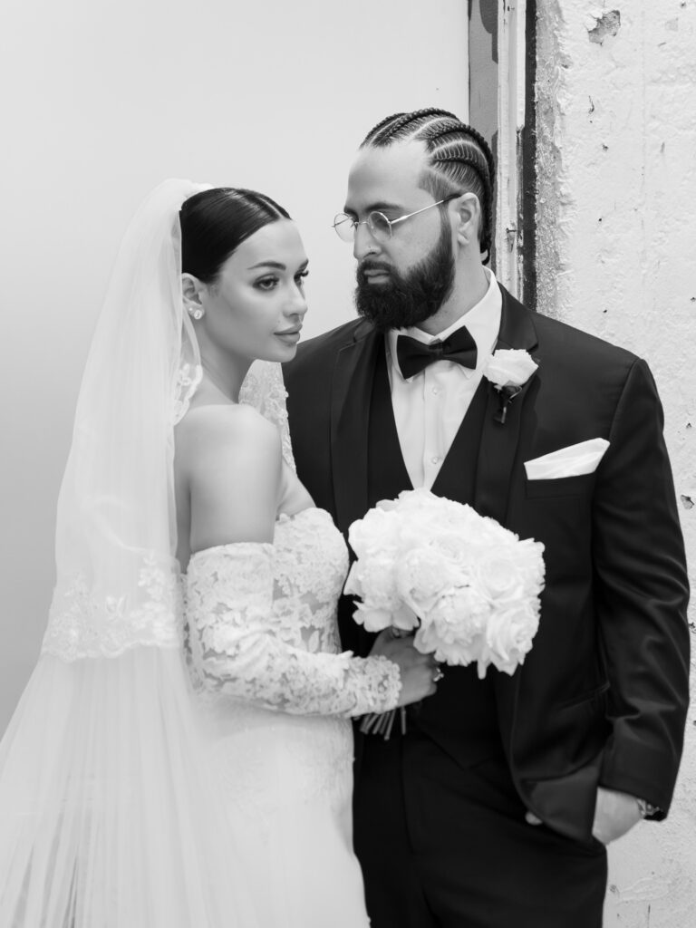 Bride and groom portrait against exposed brick wall, fine art documentary wedding photography Tampa