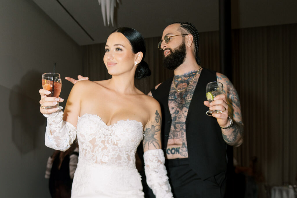 Bride and groom raising glasses during wedding reception, fine art documentary wedding photography Tampa