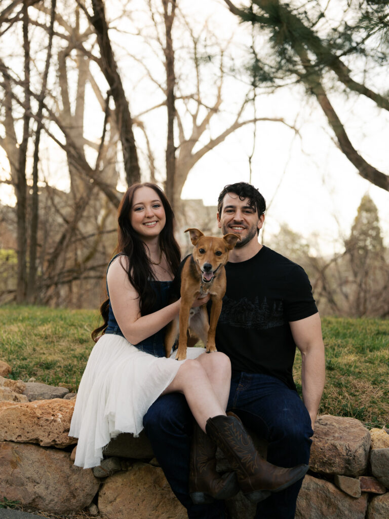 Couple sitting in some rocks at golden hour in a couples session