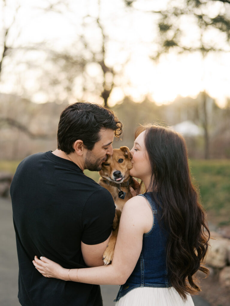 Couple kissing their dog in the forehead captured by a Reno photographer in a couples session