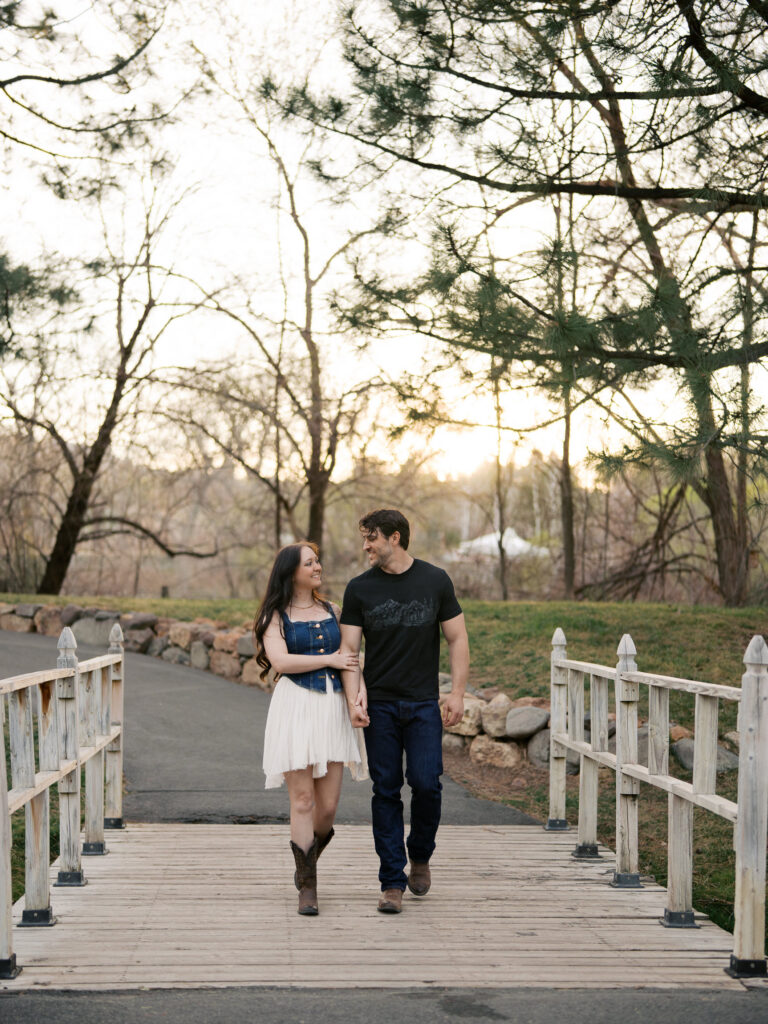 Couple walking in a small bridge captured by a Reno photographer in a couples session